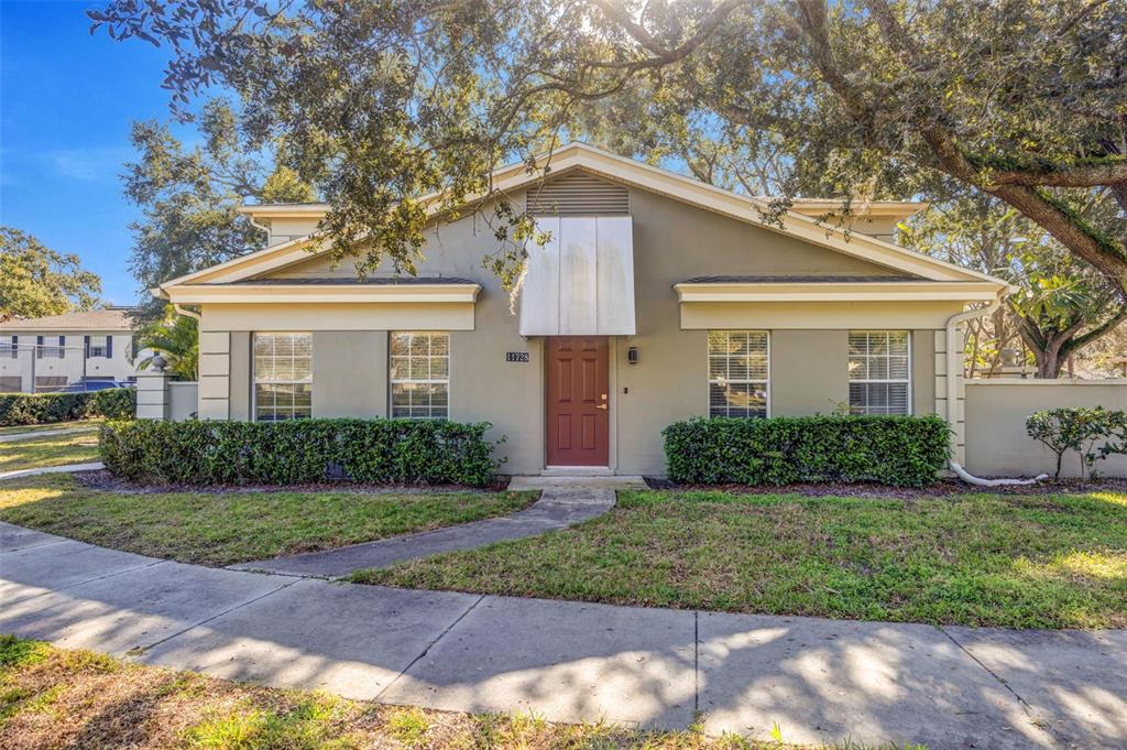 11728 Raintree Drive Temple Terrace, FL 33617 - Photo 34 of 41 a front view of a house with a yard and garage