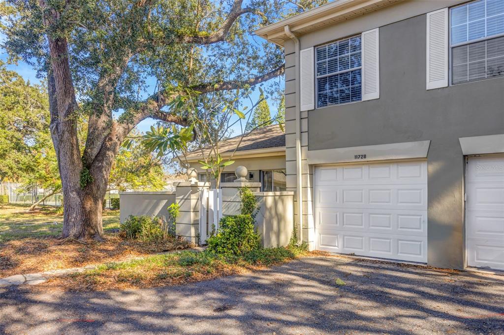 11728 Raintree Drive Temple Terrace, FL 33617 - Photo 37 of 41 a front view of a house with a yard and garage