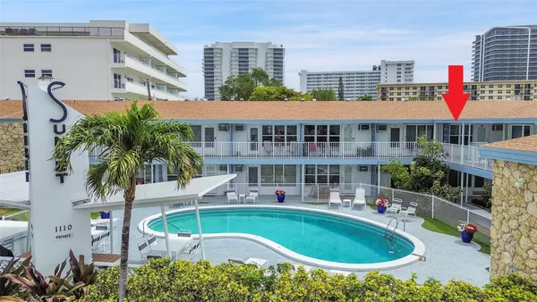a aerial view of a house with swimming pool and chairs