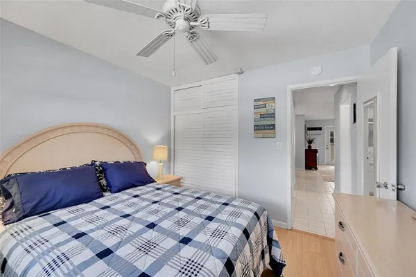 a bedroom with a large bed and a flat tv screen on dresser