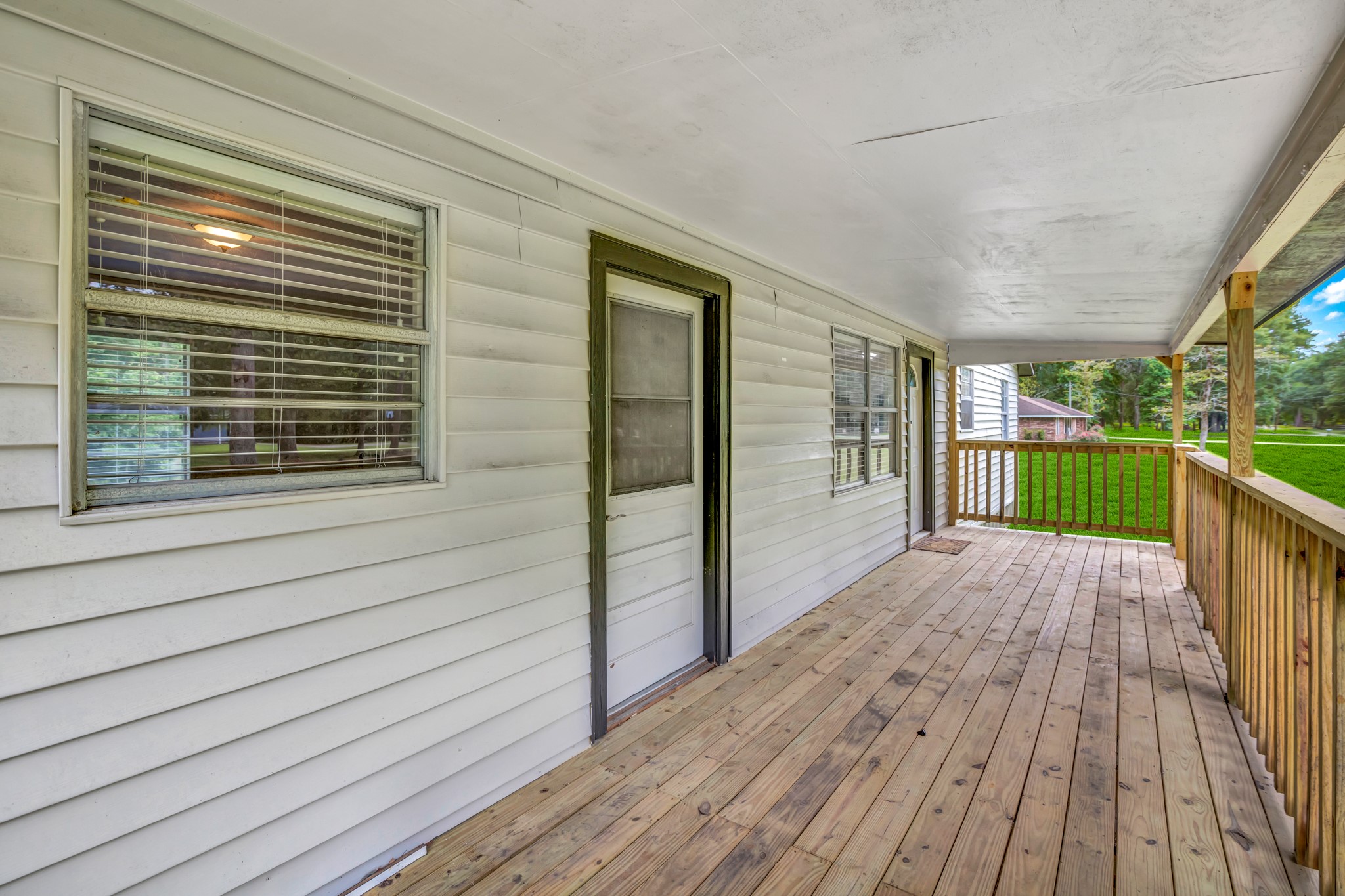 a view of backyard with deck and wooden floor