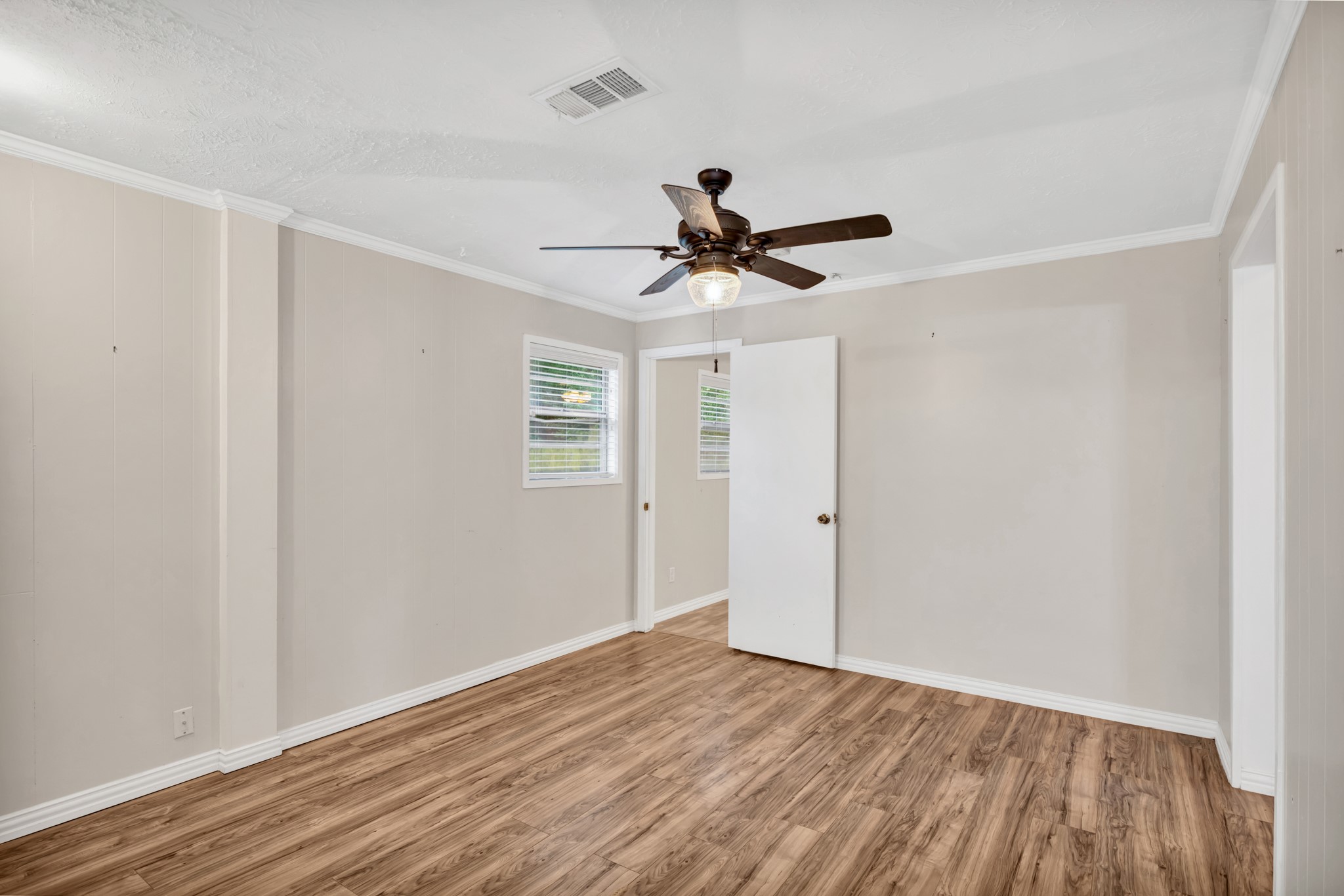10863 Autumn Lane Cleveland, TX 77328 - Photo 11 of 24 a view of a room with wooden floor and a ceiling fan