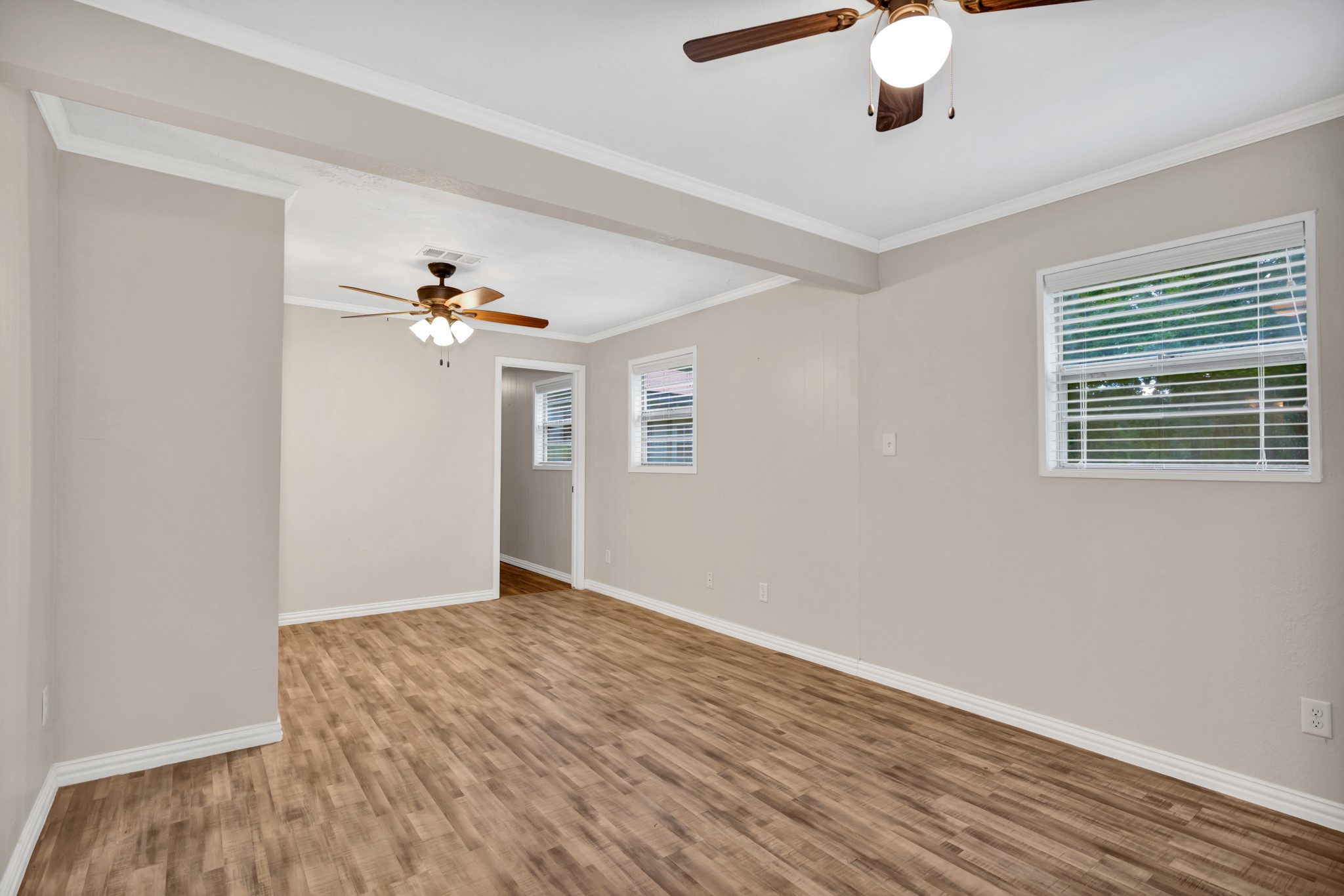 10863 Autumn Lane Cleveland, TX 77328 - Photo 13 of 24 a view of an empty room with wooden floor and a window