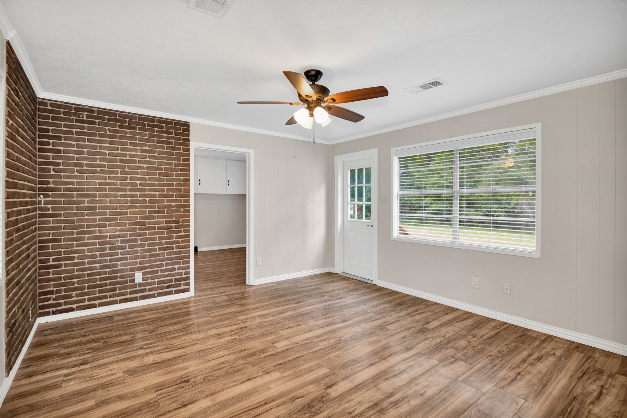 10863 Autumn Lane Cleveland, TX 77328 - Photo 2 of 24 a view of a livingroom with a chandelier fan and wooden floor