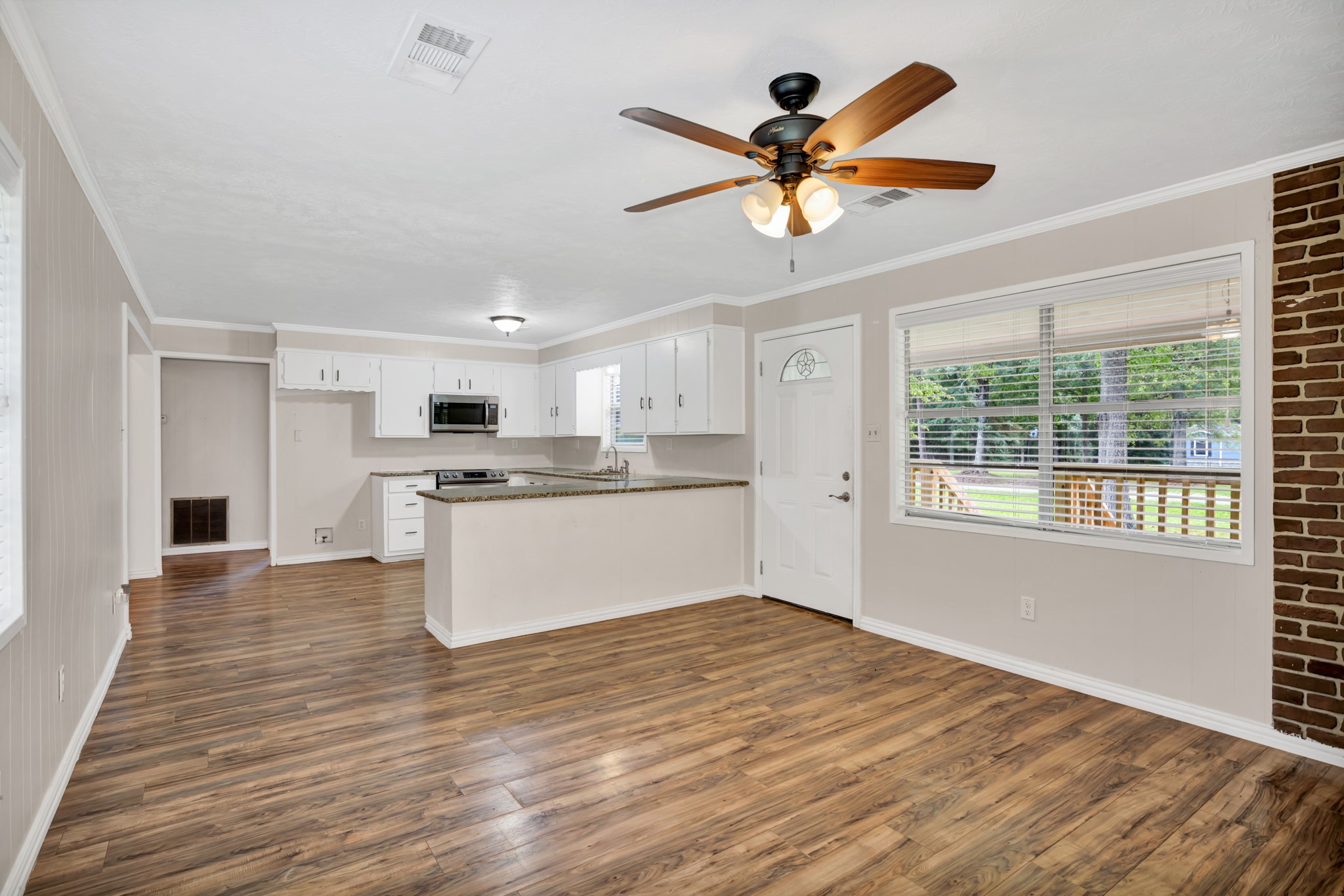 10863 Autumn Lane Cleveland, TX 77328 - Photo 4 of 24 a view of kitchen with cabinets and wooden floor