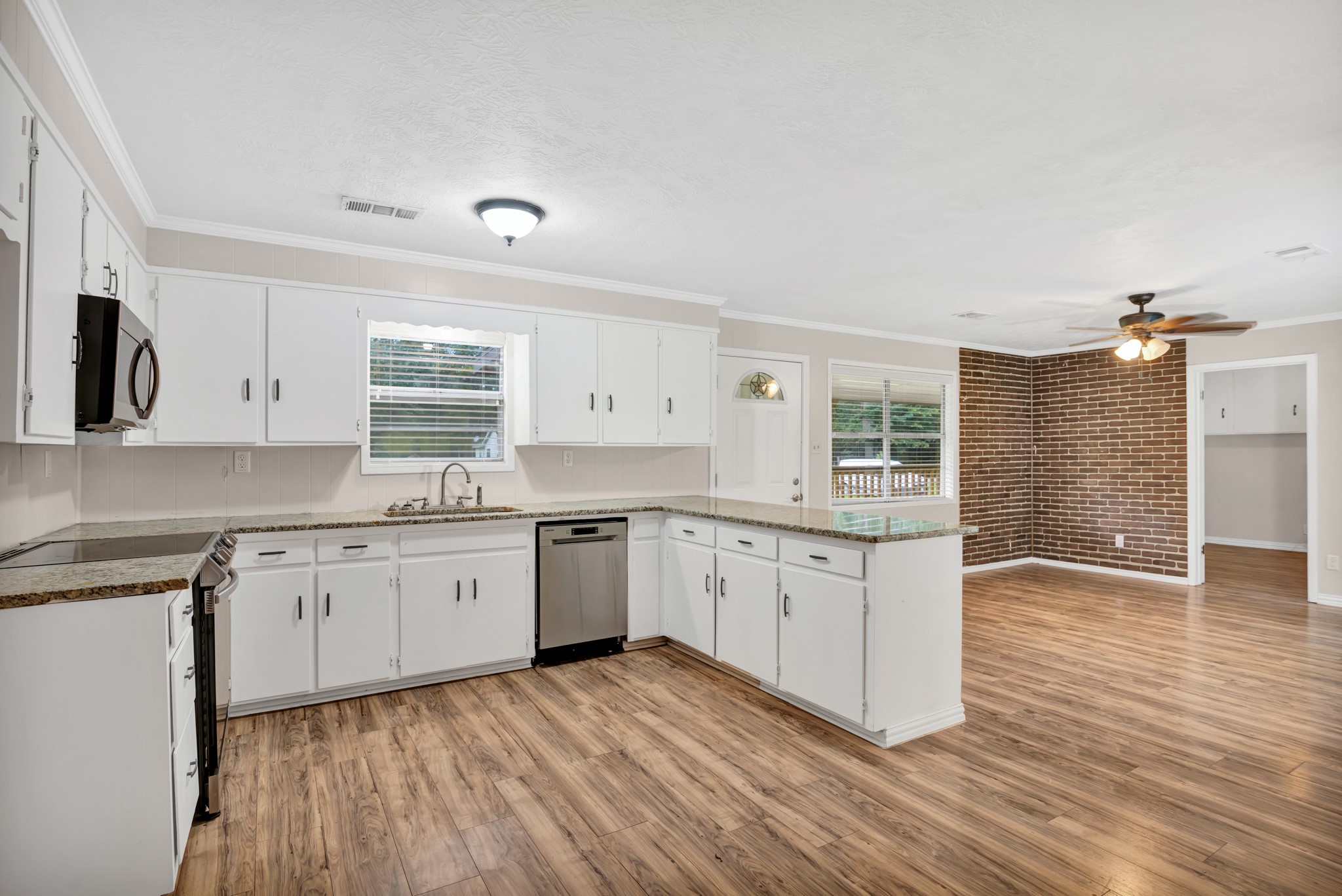 10863 Autumn Lane Cleveland, TX 77328 - Photo 7 of 24 a kitchen with granite countertop white cabinets and white appliances