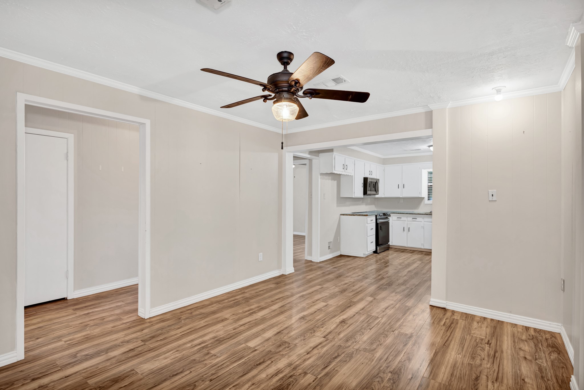 10863 Autumn Lane Cleveland, TX 77328 - Photo 10 of 24 a view of a room with wooden floor and ceiling fan