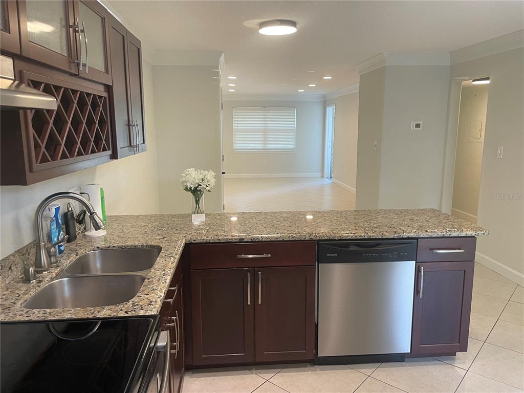 2500 Lee Road, Unit 202 Winter Park, FL 32789 - Photo 11 of 52 a kitchen with granite countertop a sink stainless steel appliances and cabinets