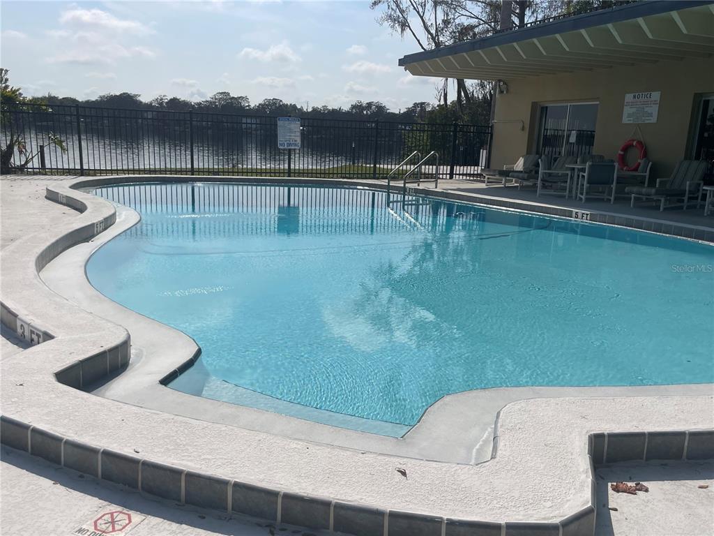 2500 Lee Road, Unit 202 Winter Park, FL 32789 - Photo 18 of 39 a view of a swimming pool with a table and chairs