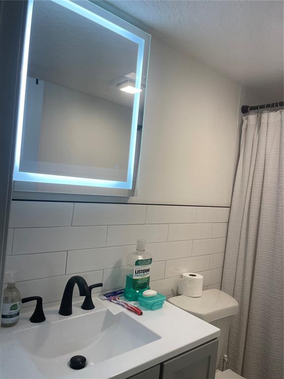 2500 Lee Road, Unit 202 Winter Park, FL 32789 - Photo 40 of 52 a bathroom with a sink and a toilet