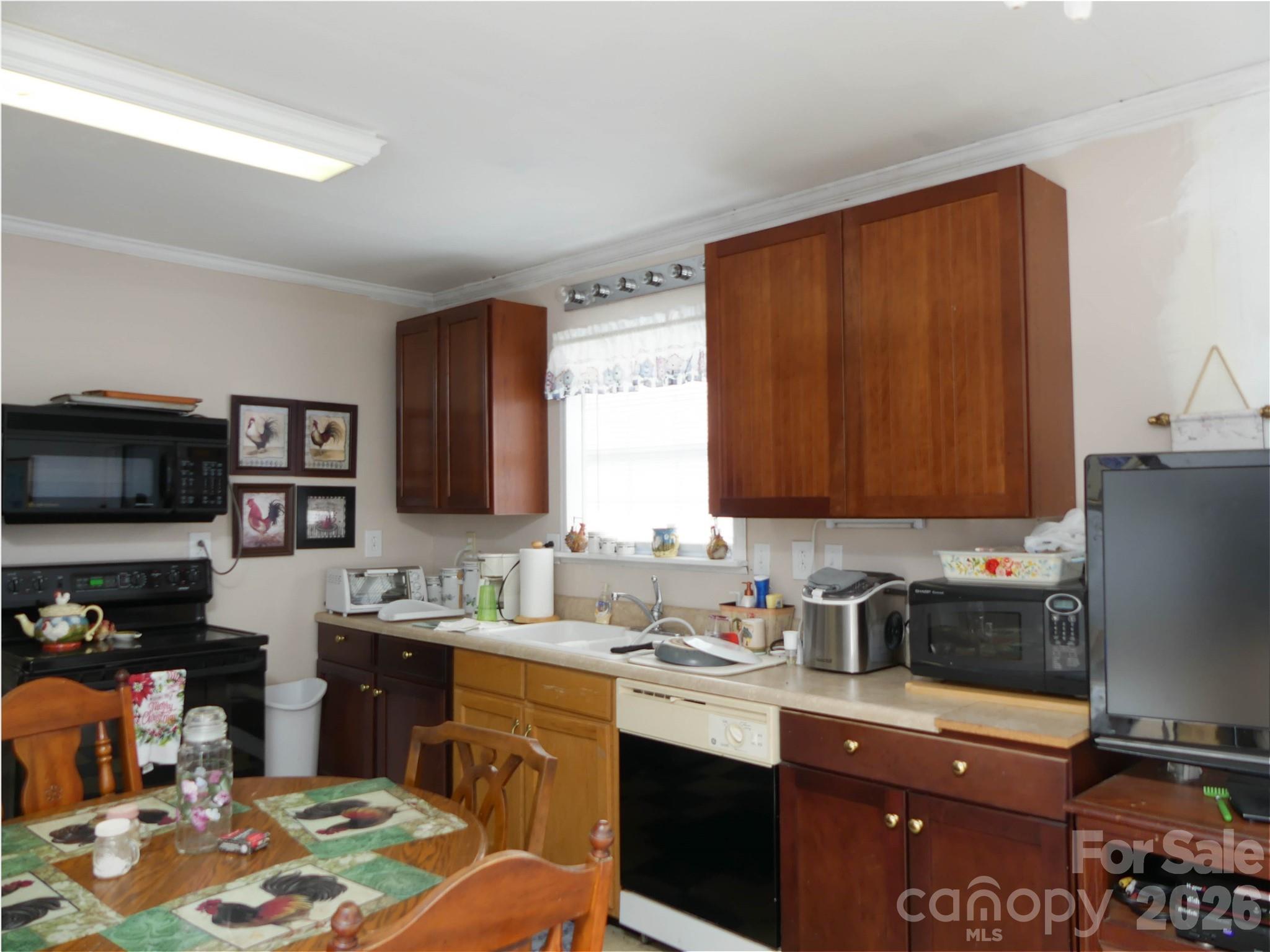 722 Union Hill Ridge Road Green Mountain, NC 28740 - Photo 18 of 21 a kitchen with stainless steel appliances granite countertop a sink refrigerator and cabinets