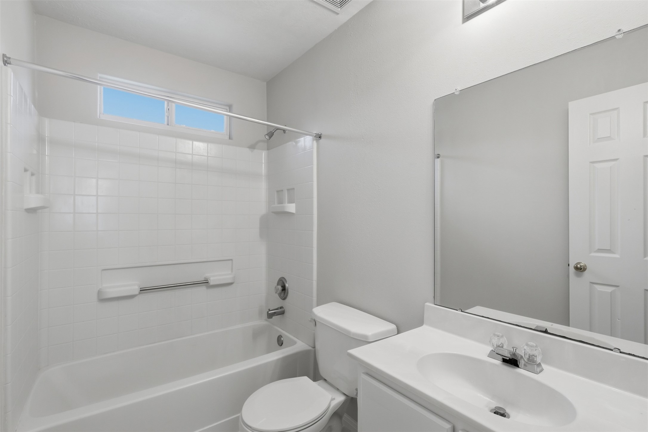 723 Slate Valley Lane Spring, TX 77373 - Photo 33 of 41 Bright upper-level secondary bath equipped with elegant marble-look tile flooring, a tub/shower combination, white vanity, and a high transom window that lets in natural light while maintaining privacy.
