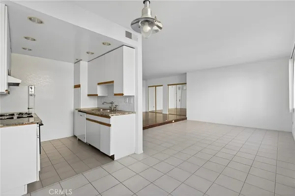 a kitchen with sink stove and cabinets