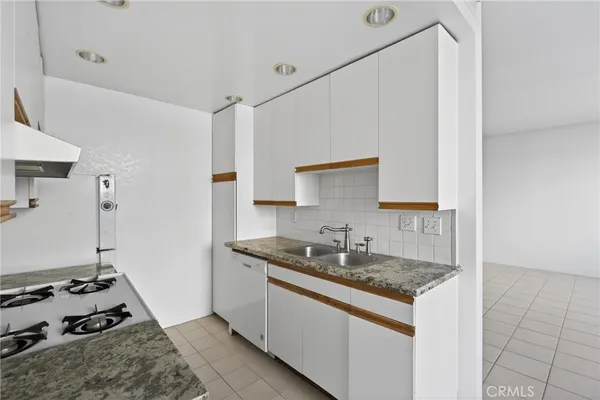 a kitchen that has a sink and a stove