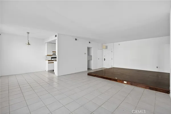 a view of kitchen and empty room