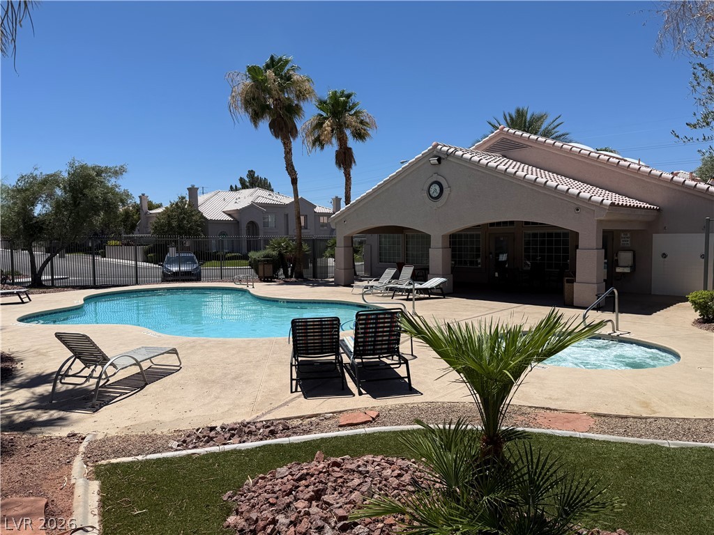 517 Crumpler Place Henderson, NV 89052 - Photo 4 of 9 Lush landscaping surrounds the shimmering pool and spa, complementing the community clubhouse.