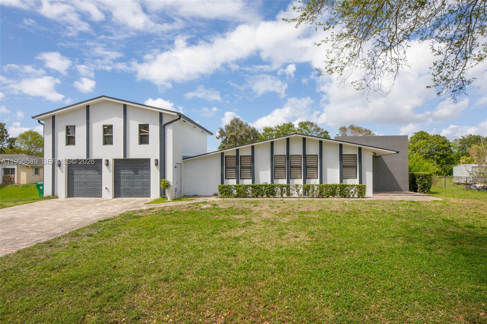 17101 Southwest 48th Street Southwest Ranches, FL 33331 - Photo 2 of 31 a front view of a house with a garden