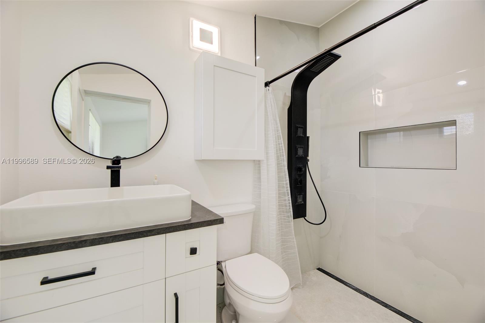 17101 Southwest 48th Street Southwest Ranches, FL 33331 - Photo 21 of 31 a bathroom with a toilet a sink and mirror
