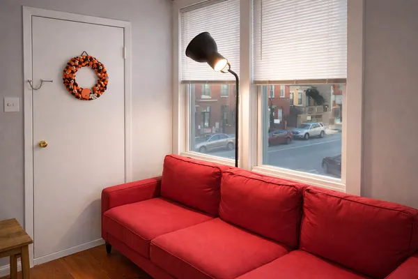 a blue room with wooden floor and a large window