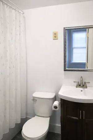 a bathroom with a toilet a sink and a mirror