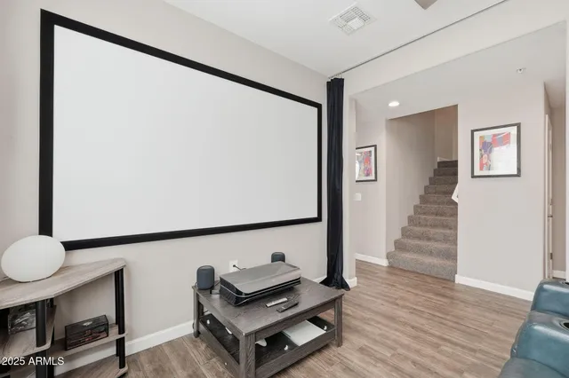 a living room with wooden floor and furniture