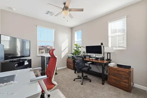 a view of a workspace with furniture and a window