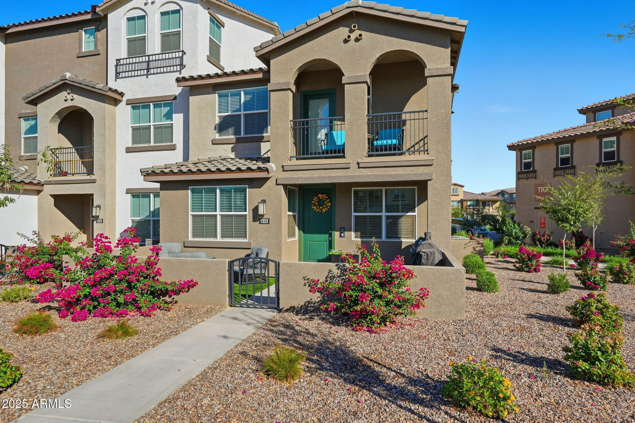 1255 North Arizona Avenue, Unit 1323 Chandler, AZ 85225 - Photo 2 of 30 a front view of a house with an outdoor space