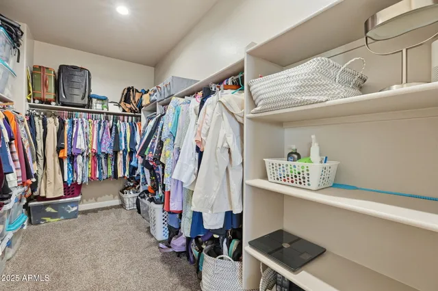 a view of walk in closet with clothes