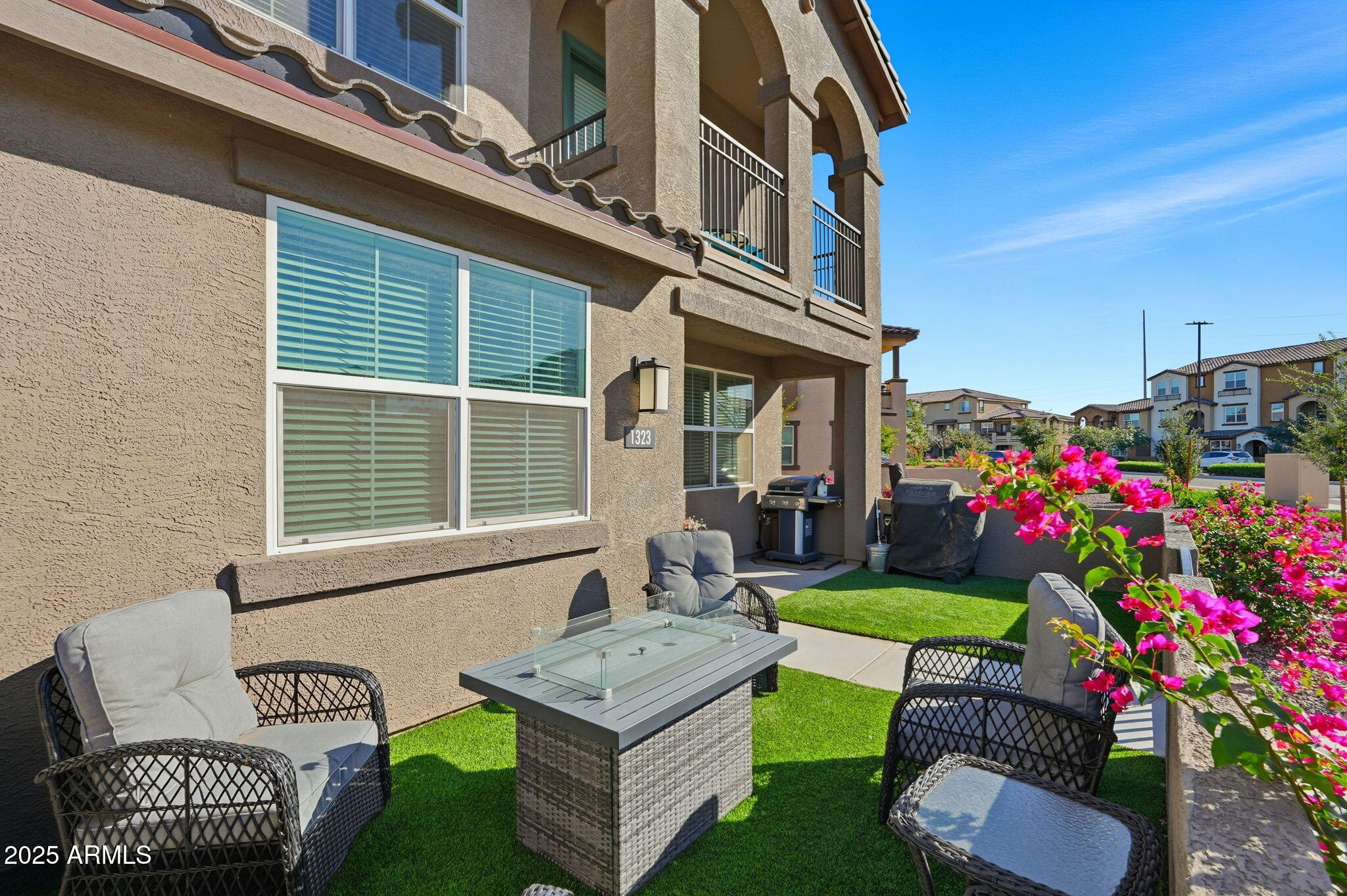 1255 North Arizona Avenue, Unit 1323 Chandler, AZ 85225 - Photo 27 of 30 a front view of a house with a garden and patio