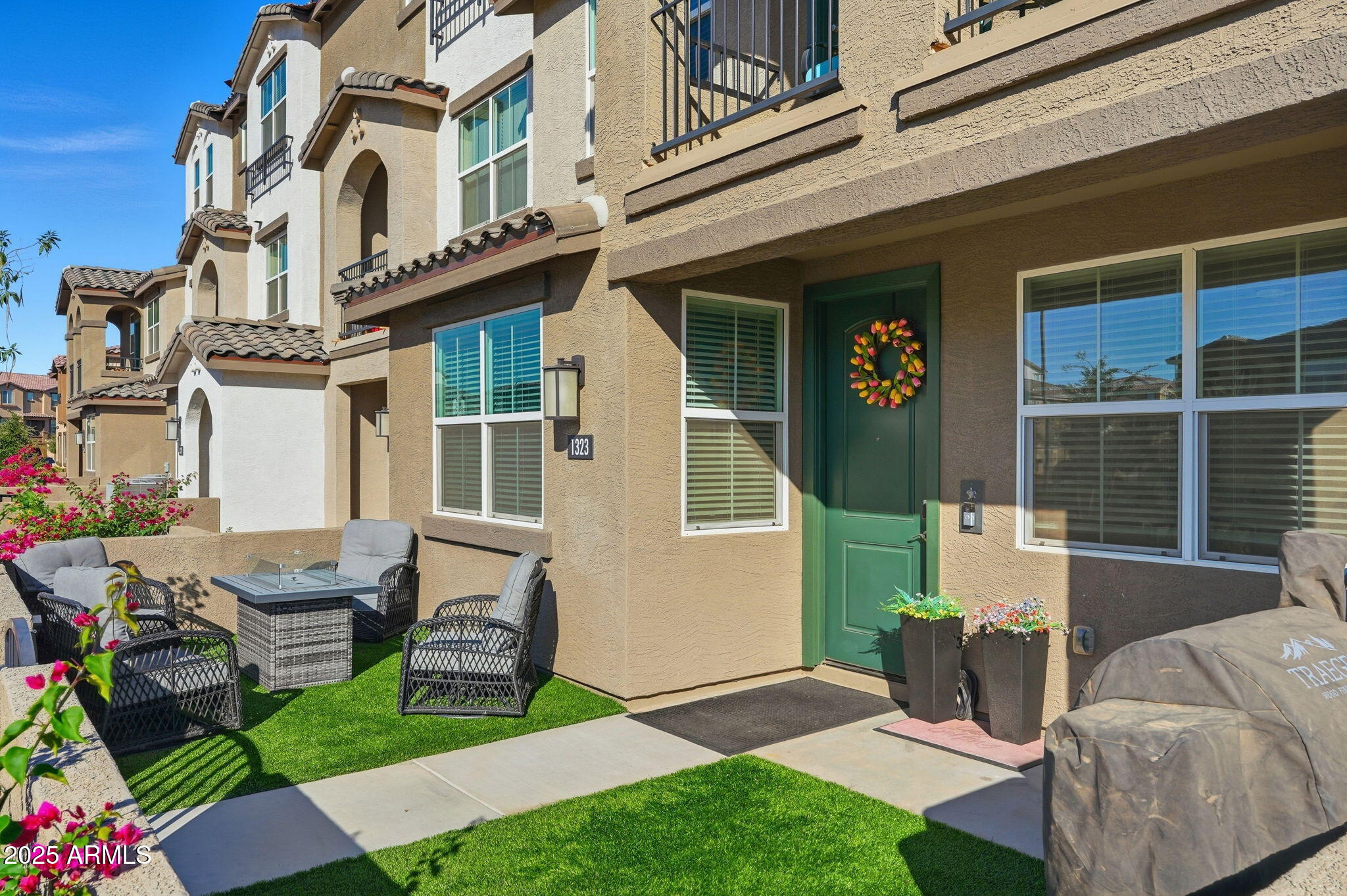 1255 North Arizona Avenue, Unit 1323 Chandler, AZ 85225 - Photo 3 of 30 a front view of a house with garden