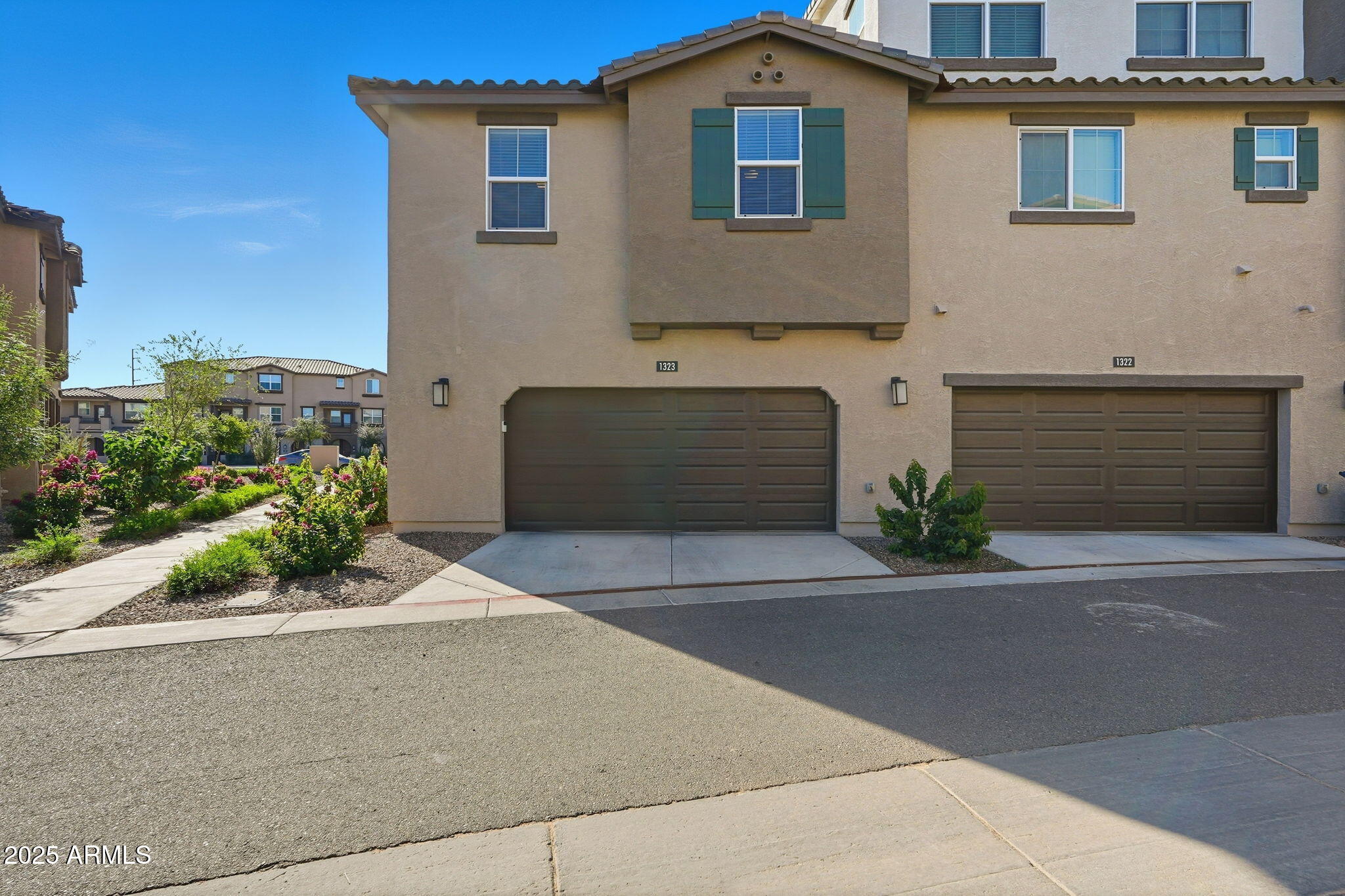 1255 North Arizona Avenue, Unit 1323 Chandler, AZ 85225 - Photo 4 of 30 a front view of a house with a yard and garage