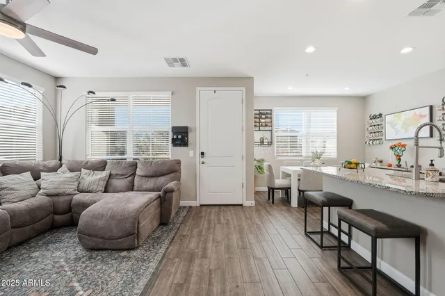 a living room with furniture and wooden floor