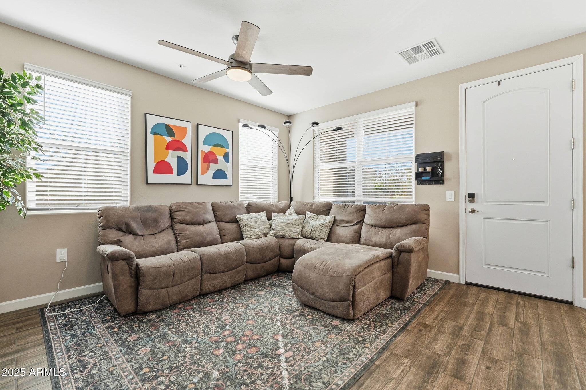 1255 North Arizona Avenue, Unit 1323 Chandler, AZ 85225 - Photo 6 of 30 a living room with furniture ceiling fan and a window