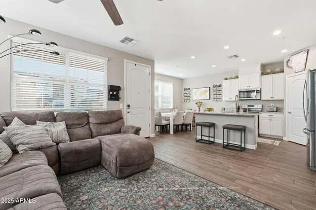 a living room with furniture and a large window