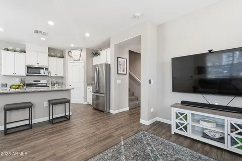 a kitchen with stainless steel appliances a stove a sink and a refrigerator