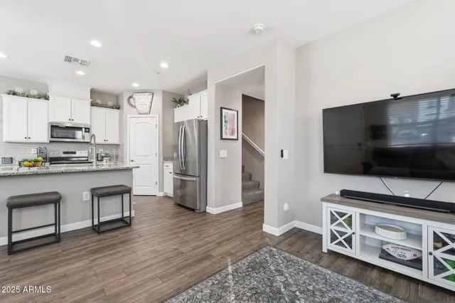 a kitchen with stainless steel appliances a stove a sink and a refrigerator