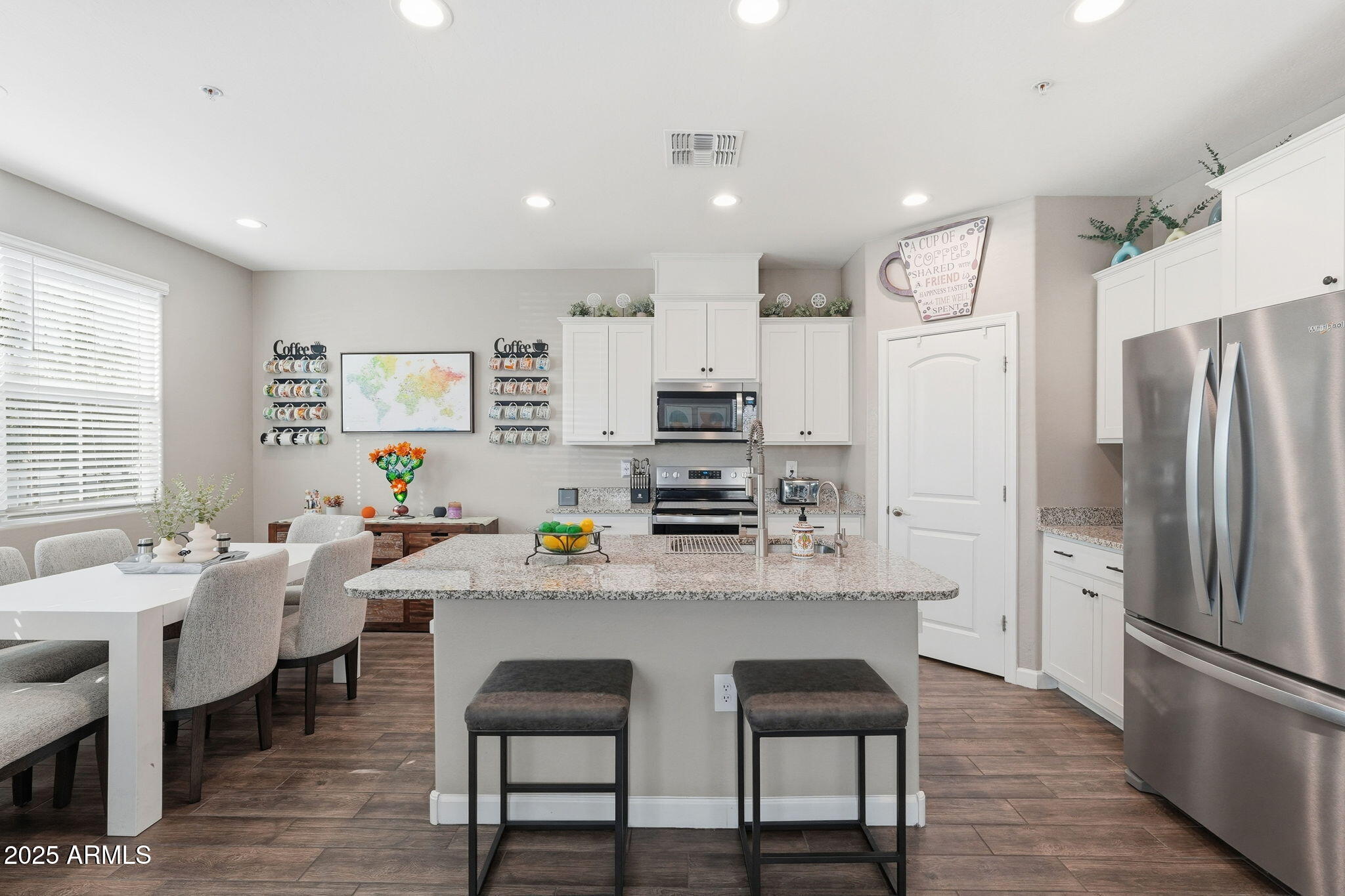 1255 North Arizona Avenue, Unit 1323 Chandler, AZ 85225 - Photo 9 of 30 a kitchen with stainless steel appliances a dining table chairs refrigerator and sink