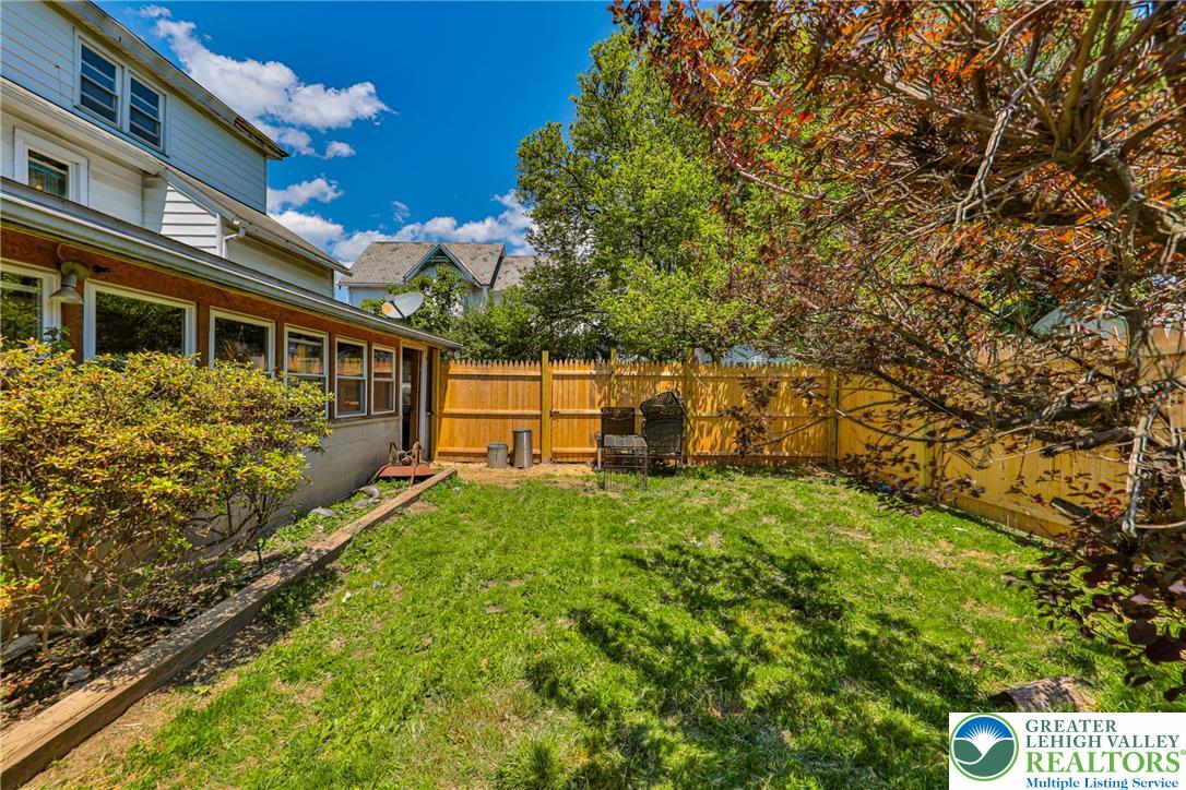 417 3rd Street Lehighton, PA 18235 - Photo 31 of 39 A vibrant green lawn extends to a new wood fence, providing a private outdoor space.