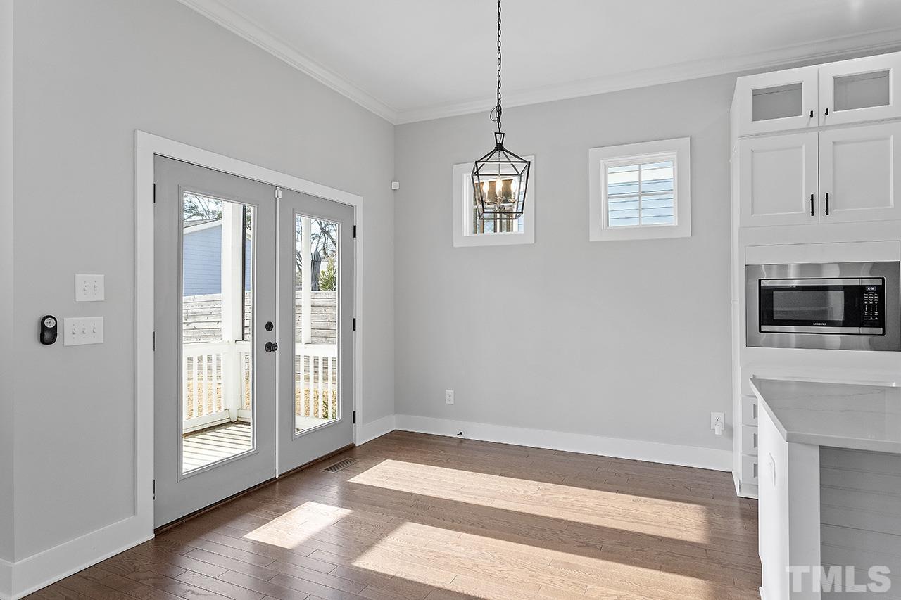 2320.5 Milburnie Road Raleigh, NC 27610 - Photo 13 of 32 a view of an empty room with wooden floor and a window