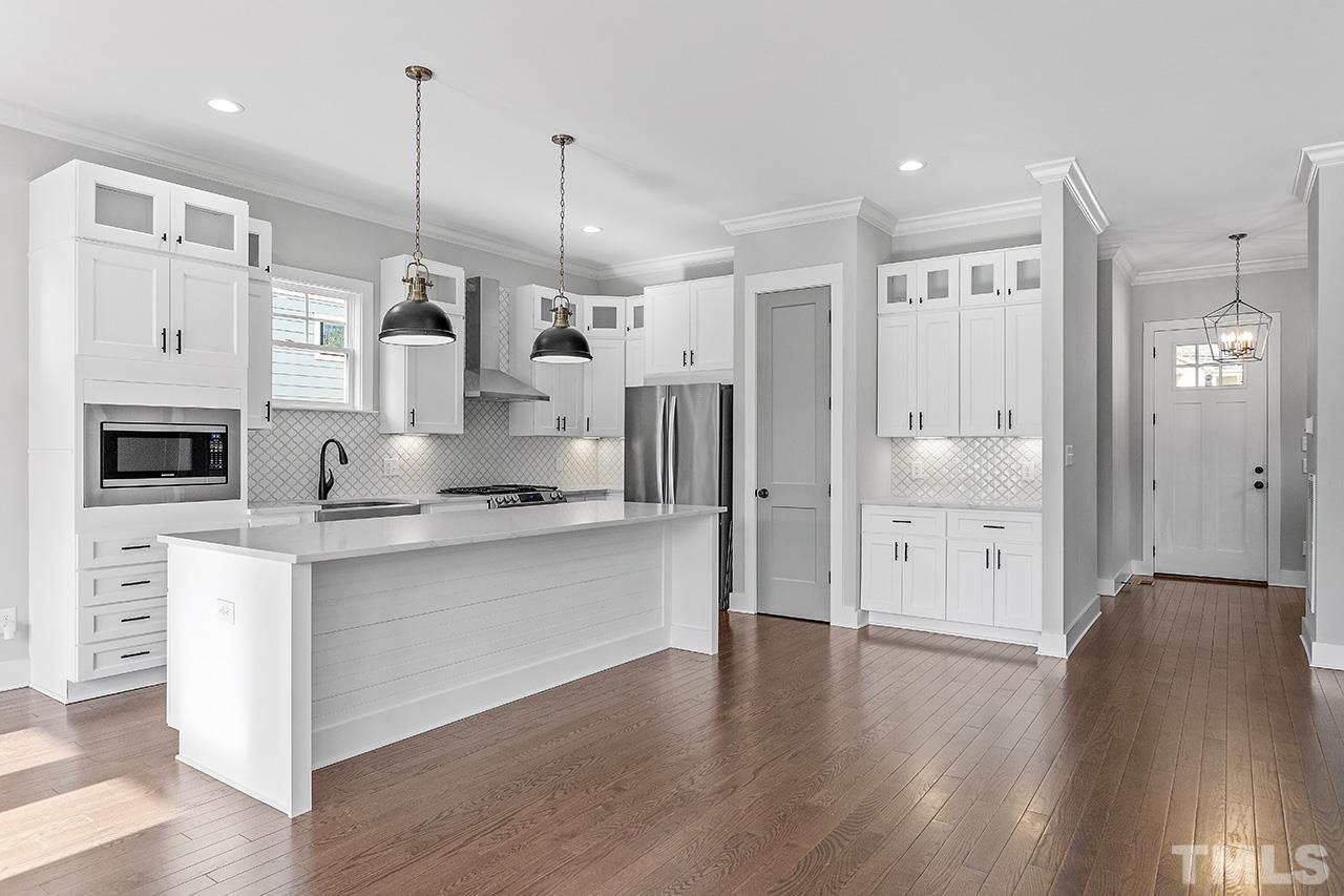 2320.5 Milburnie Road Raleigh, NC 27610 - Photo 14 of 32 a large kitchen with a lot of counter space and wooden floor
