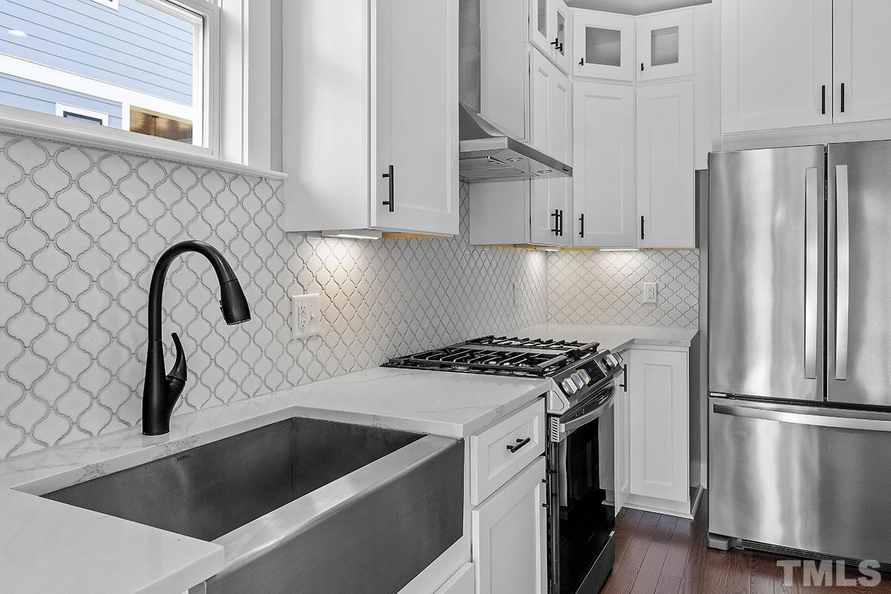 2320.5 Milburnie Road Raleigh, NC 27610 - Photo 17 of 32 a kitchen with granite countertop a sink stove and refrigerator