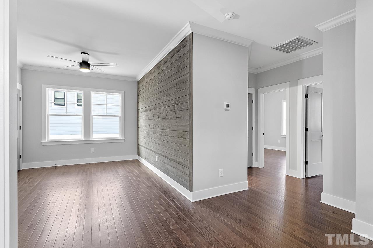 2320.5 Milburnie Road Raleigh, NC 27610 - Photo 21 of 32 wooden floor in an empty room with a window