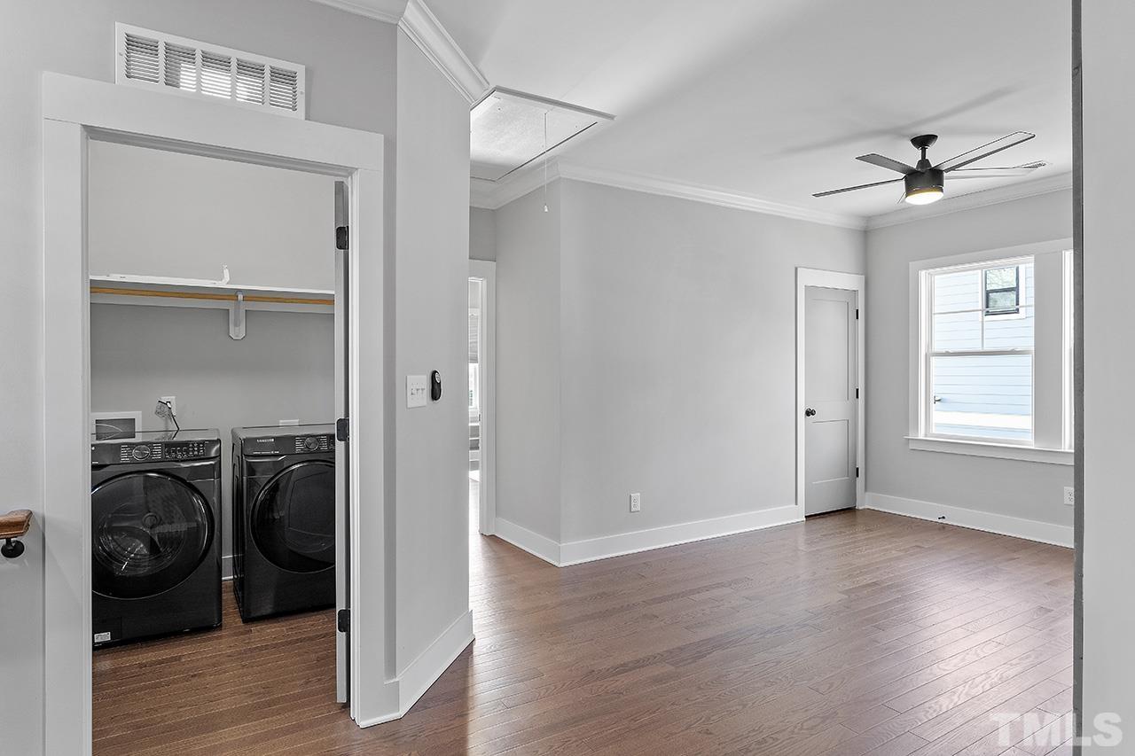 2320.5 Milburnie Road Raleigh, NC 27610 - Photo 22 of 32 a view of a livingroom with a window and wooden floor