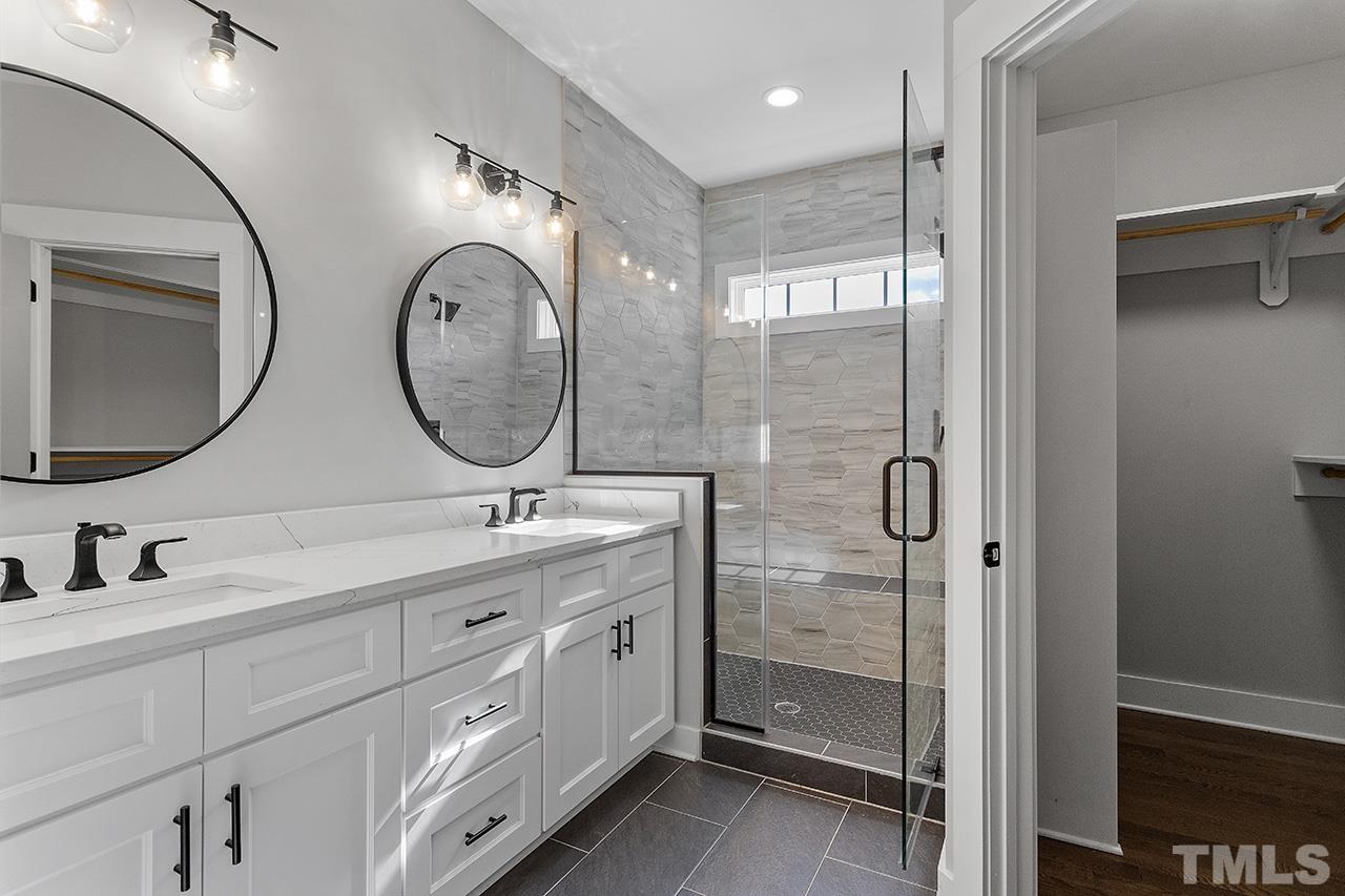 2320.5 Milburnie Road Raleigh, NC 27610 - Photo 26 of 32 a bathroom with 2 sink and a mirror