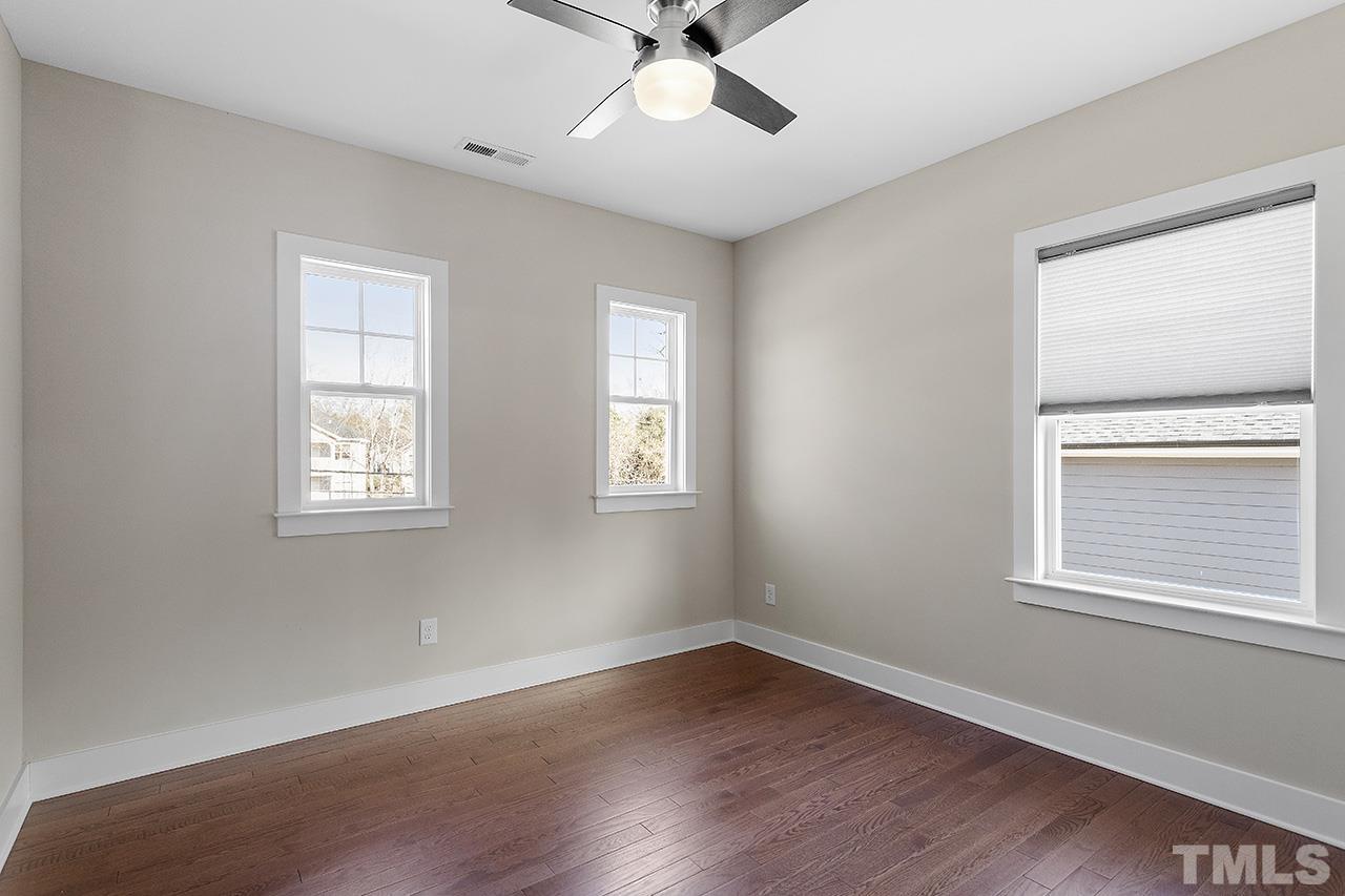 2320.5 Milburnie Road Raleigh, NC 27610 - Photo 27 of 32 a view of an empty room with wooden floor and a window