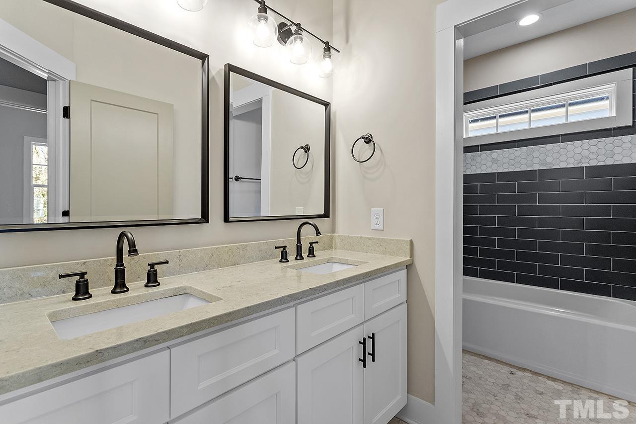 2320.5 Milburnie Road Raleigh, NC 27610 - Photo 29 of 32 a bathroom with a sink and a mirror