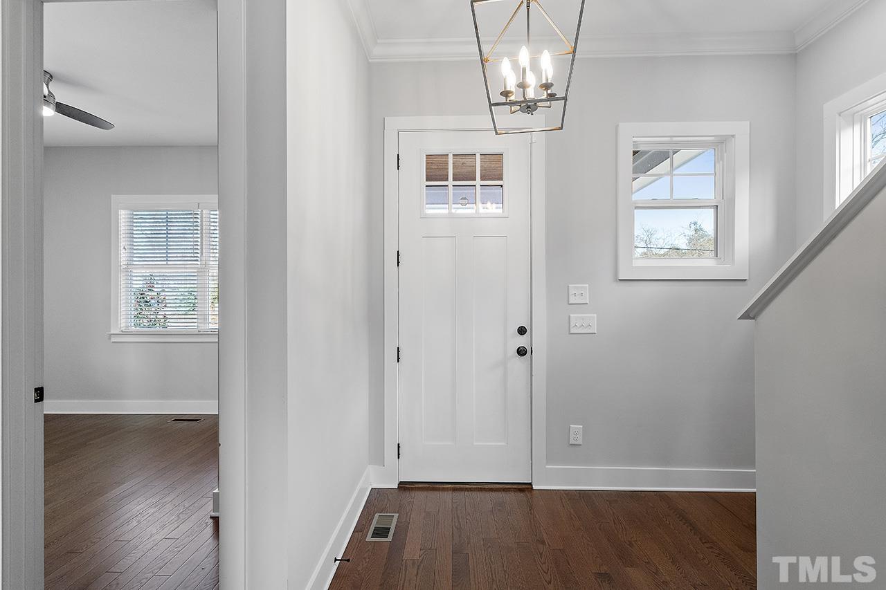 2320.5 Milburnie Road Raleigh, NC 27610 - Photo 3 of 32 wooden floor in an empty room with a window