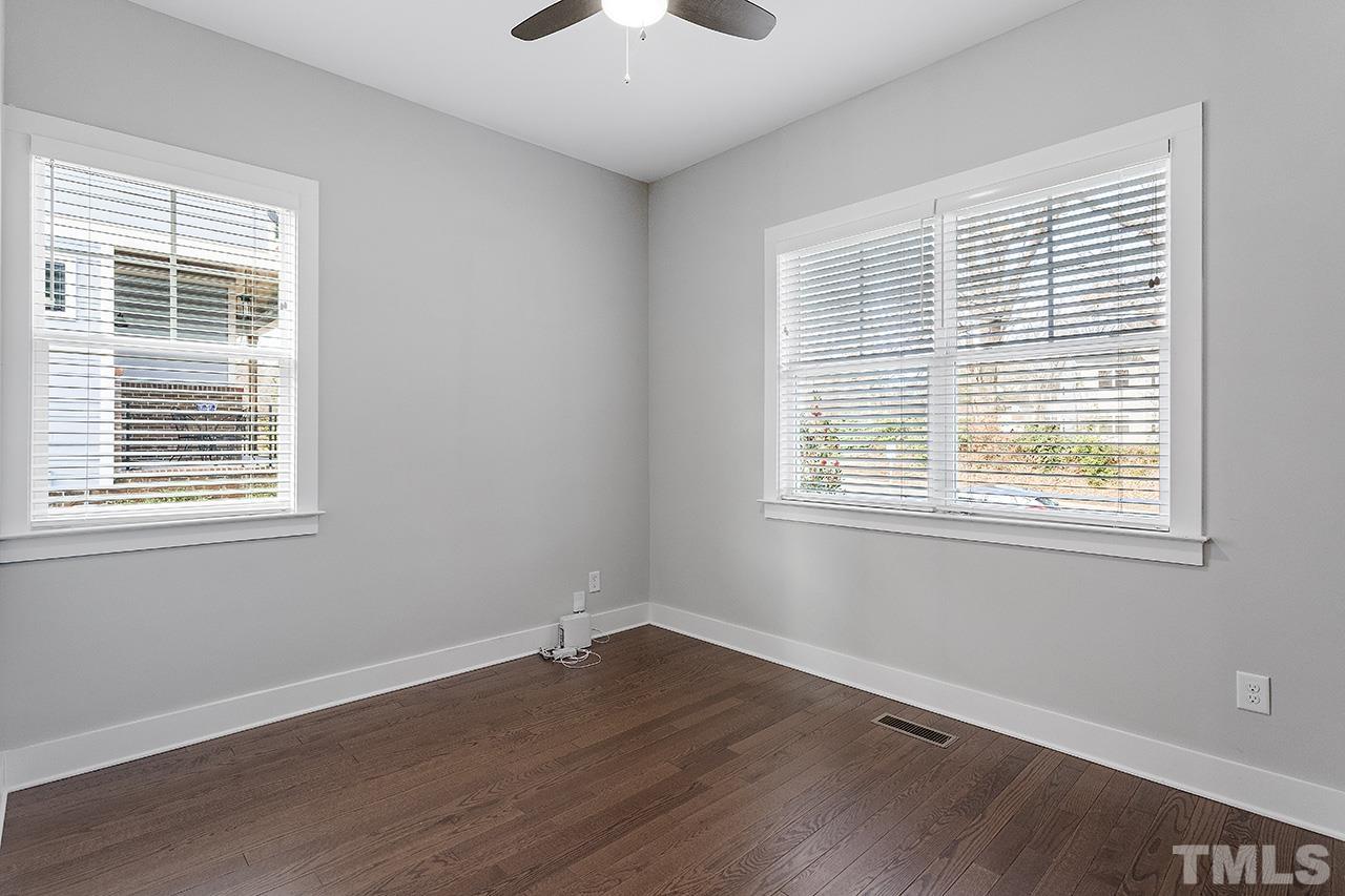 2320.5 Milburnie Road Raleigh, NC 27610 - Photo 4 of 32 a view of an empty room with wooden floor and a window
