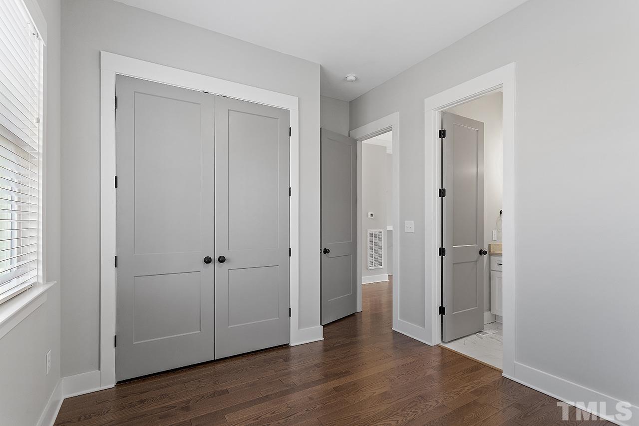 2320.5 Milburnie Road Raleigh, NC 27610 - Photo 5 of 32 an empty room with wooden floor & closet area