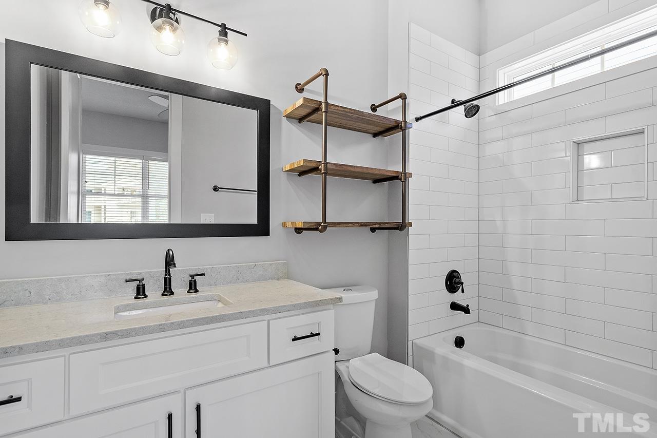 2320.5 Milburnie Road Raleigh, NC 27610 - Photo 6 of 32 a bathroom with a sink a toilet and shower
